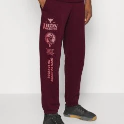 Under Armour TERRY - Spodnie Treningowe - Dark Maroon/deco Rose