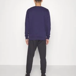 Under Armour RIVAL JOGGERS - Spodnie Treningowe - Black/white -Under Armour shop 3f18512ac56a4db597c72c91702dfeb6 scaled