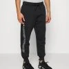 Under Armour RIVAL GRAPHIC JOGGER - Spodnie Treningowe - Black/white