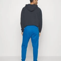 Under Armour RIVAL JOGGERS - Spodnie Treningowe - Varsity Blue/white -Under Armour shop a614ad2683fd40c985e38724b87394e5 scaled