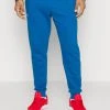 Under Armour RIVAL JOGGERS - Spodnie Treningowe - Varsity Blue/white